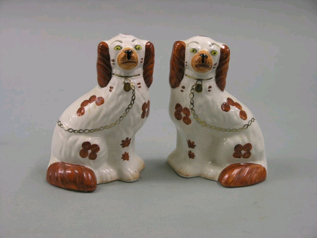 Appraisal: A pair of Staffordshire comforter spaniels th century painted in