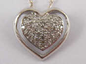 Appraisal: A white metal tests carat gold diamond set heart pendant