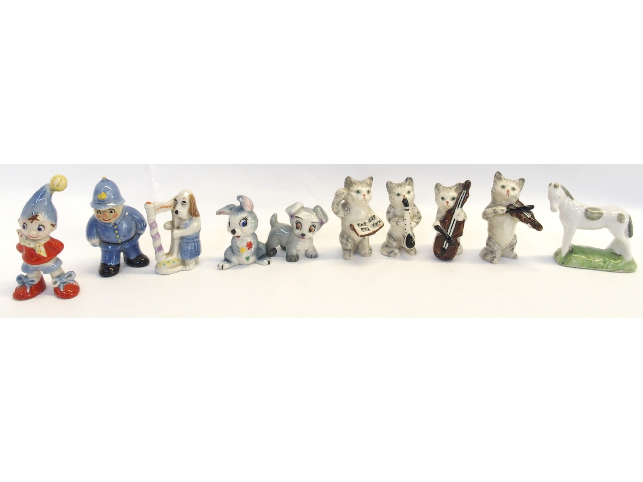 Appraisal: Group of small porcelain figures including cat musical band of