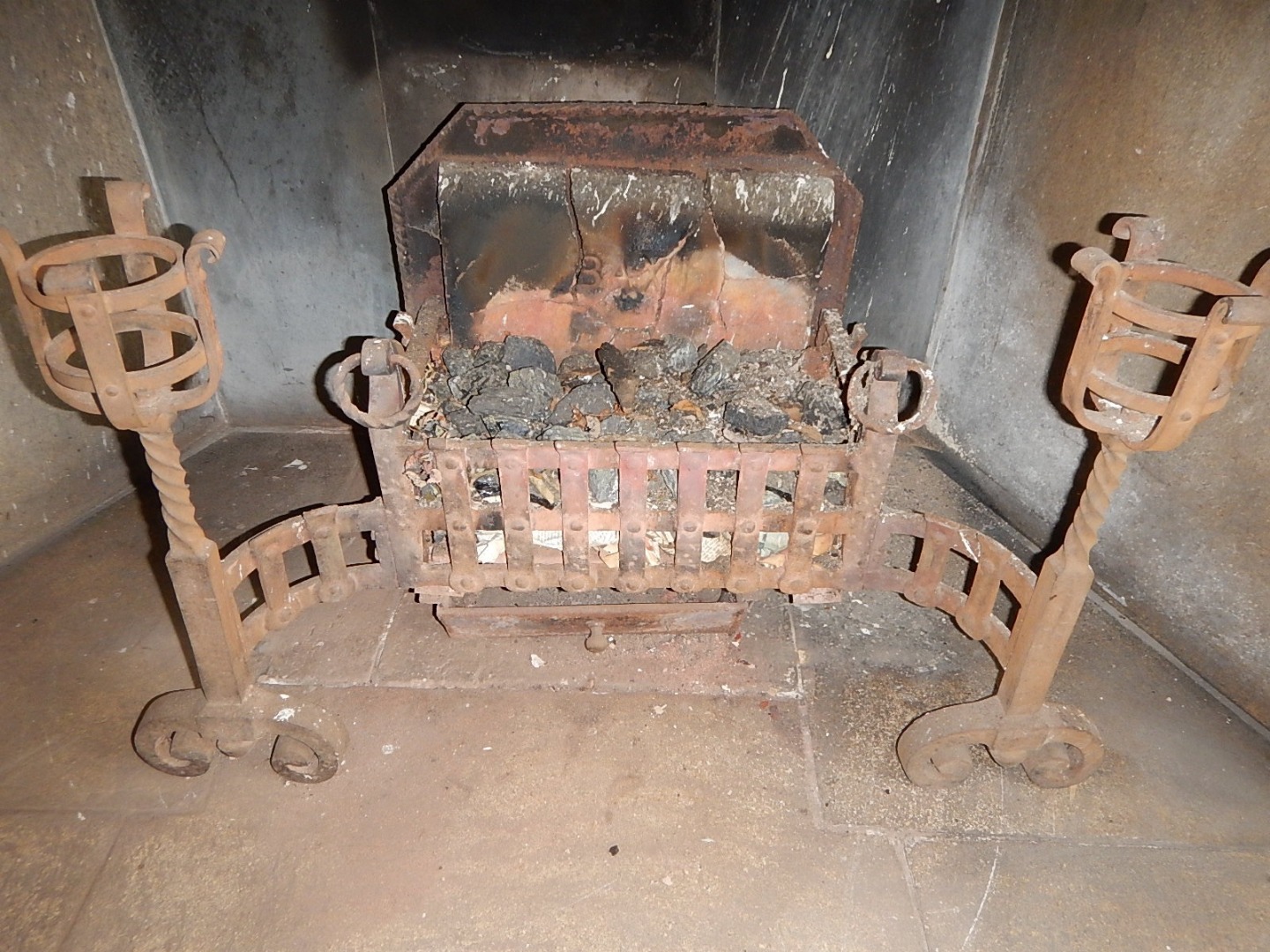 Appraisal: A heavy cast iron fire basket on scroll supports