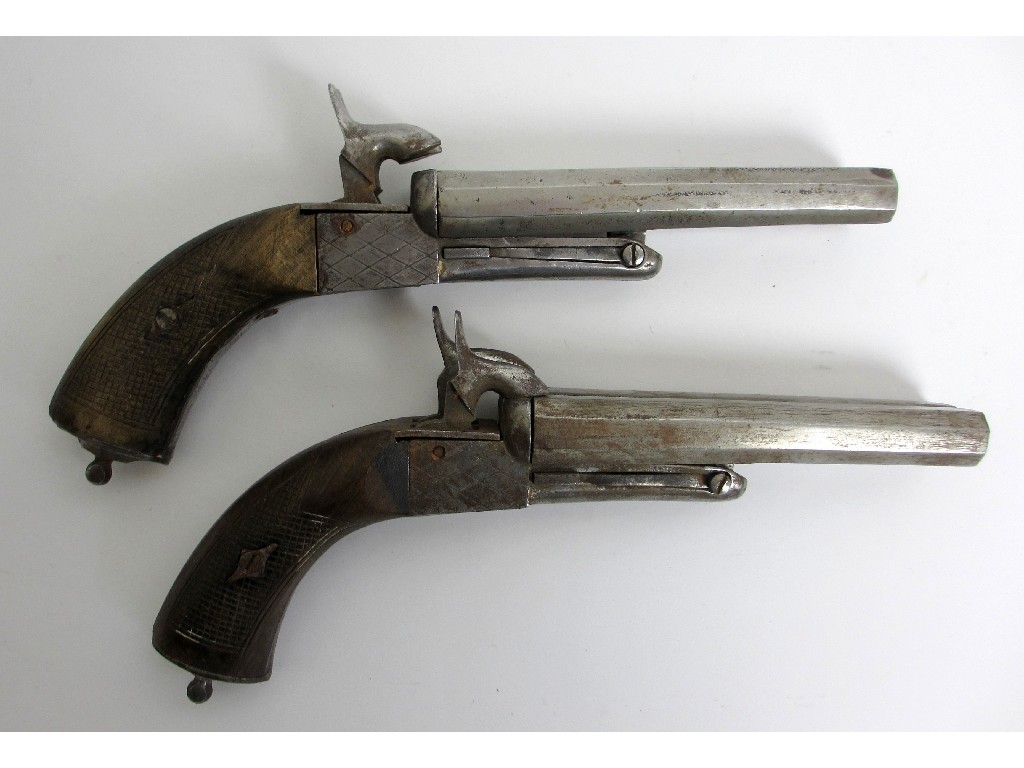 Appraisal: A pair of steel double barrelled pistols with chequered walnut