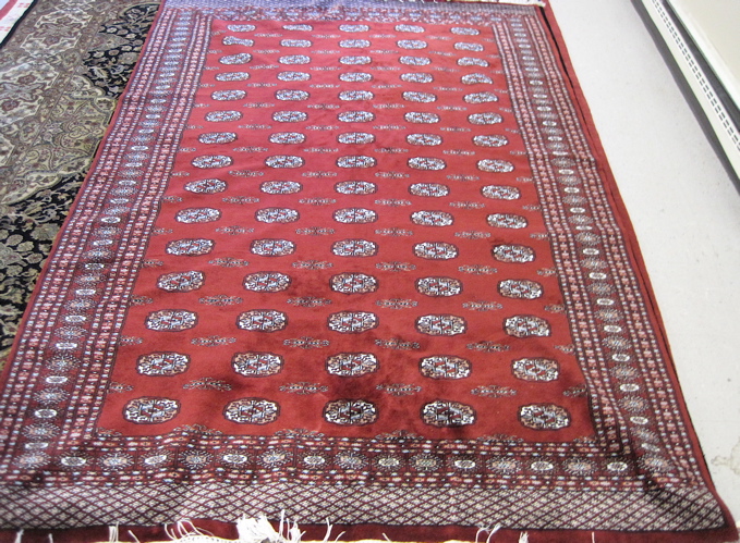 Appraisal: PAKISTANI BOKHARA CARPET repeating columns of Turkoman gols on red