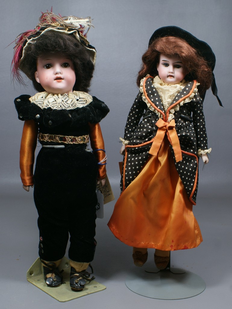 Appraisal: German Bisque Shoulder head Dolls with well coordinated costumes the