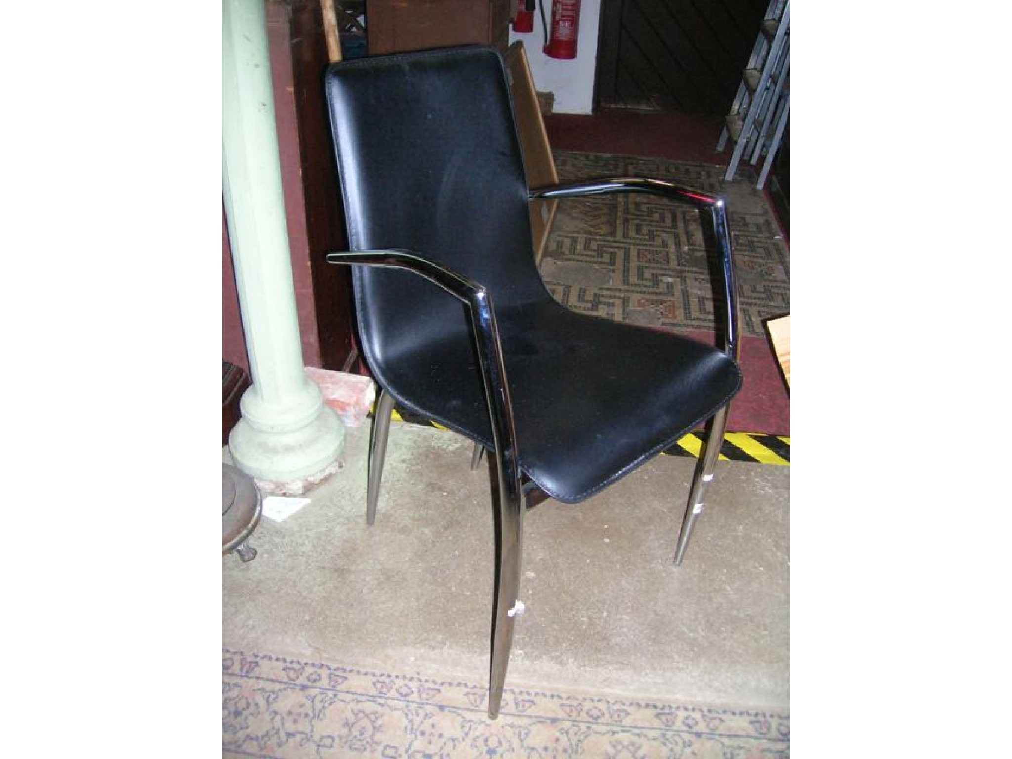 Appraisal: A contemporary open elbow chair with leather padded seat and