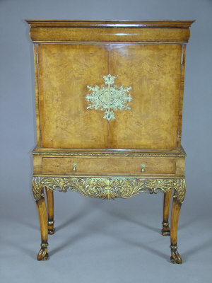 Appraisal: A 's burr walnut cocktail cabinet the moulded top and