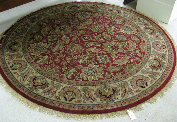 Appraisal: A ROUND ORIENTAL CARPET Indo-Persian overall floral design on madder