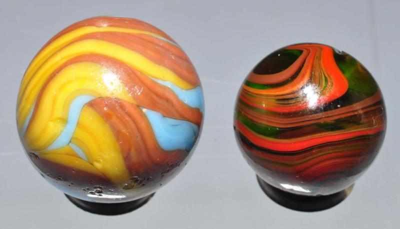 Appraisal: Lot of Christensen Agate Marbles Description Larger is a tri-color