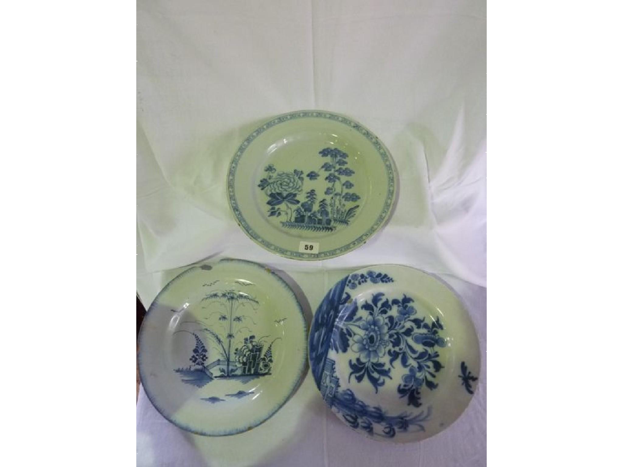 Appraisal: Five blue and white Delft dishes decorated with garden scenes