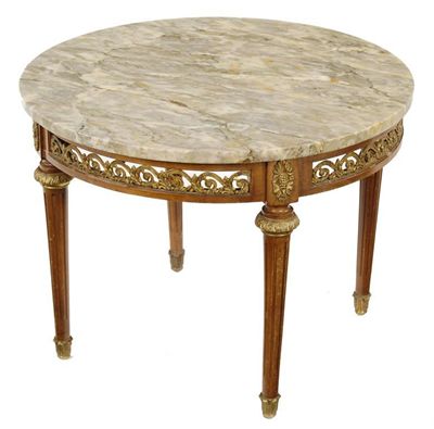 Appraisal: A continental low table the circular marble top above a