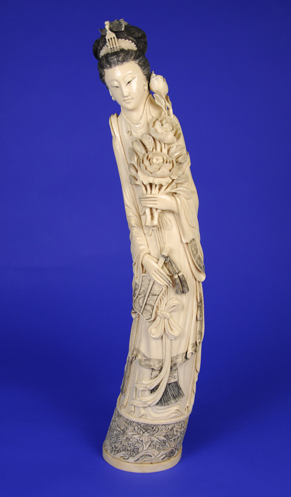 Appraisal: CHINESE CARVED IVORY FIGURE OF A DEITY th century bears