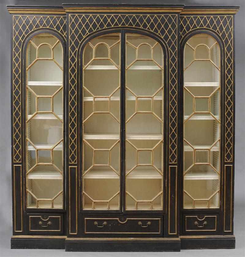 Appraisal: CHIPPENDALE STYLE BLACK-PAINTED AND PARCEL-GILT BREAKFRONT BOOKCASE Enclosed by four