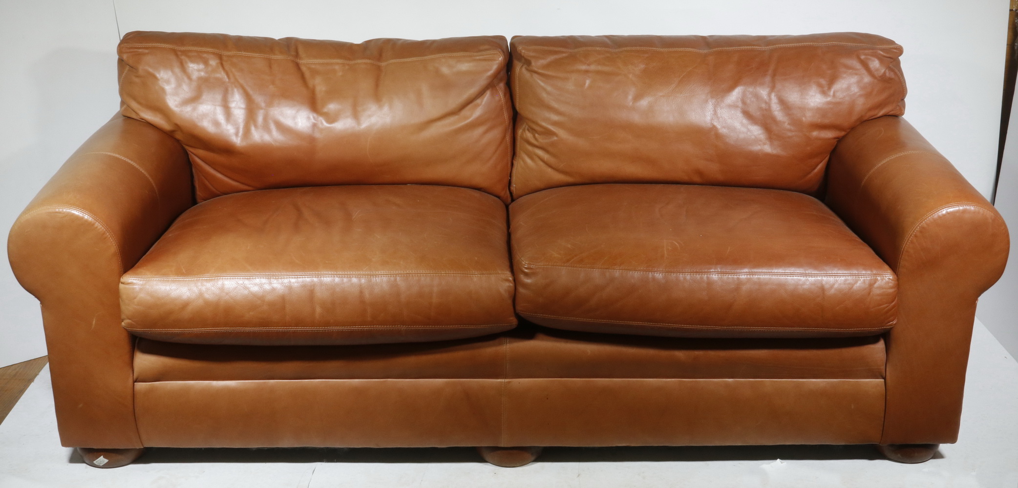 Appraisal: CONTEMPORARY SMITH BROTHERS LEATHER SOFA Contemporary two-cushion leather sofa made