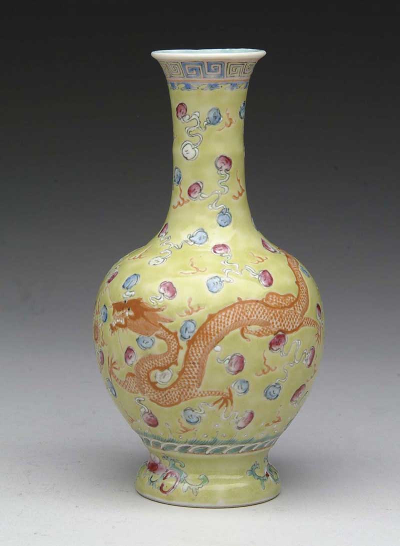 Appraisal: SMALL ORIENTAL BUD VASE Yellow ground supports two orange dragons