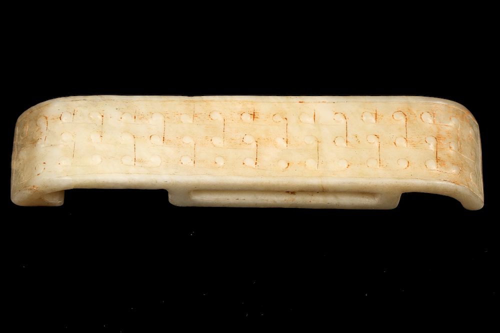 Appraisal: CHICKEN-BONE WHITE JADE SCABBARD SLIDE Carved scabbard slide of rectangular