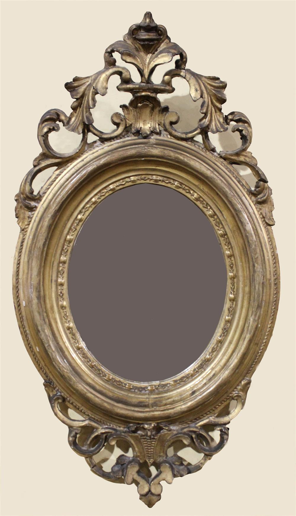 Appraisal: REGENCY CARVED GILT OVAL MIRROR having a pierced arching carved