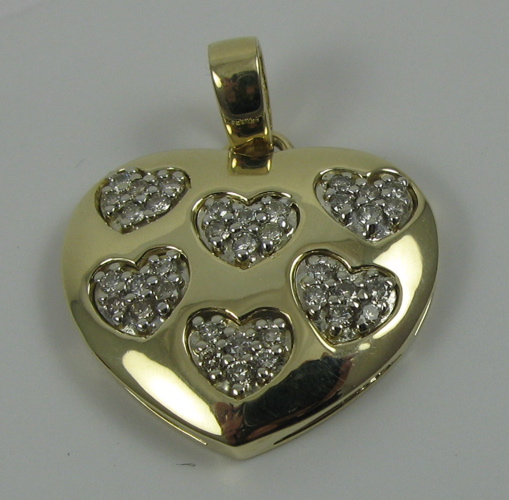 Appraisal: DIAMOND AND FOURTEEN KARAT GOLD HEART PENDANT set with round-cut