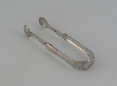 Appraisal: A pair of George III Scottish bright-cut sugar tongs with