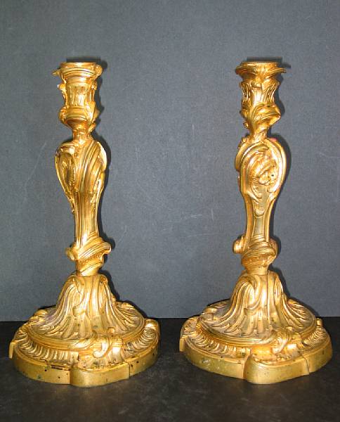 Appraisal: A pair of Louis XV style gilt bronze candlesticks mid-