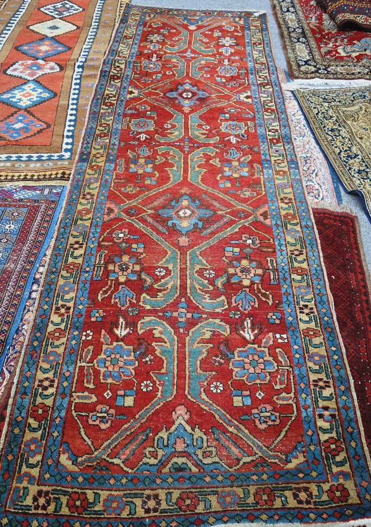 Appraisal: An Heriz runner Persian the madder field with two indigo