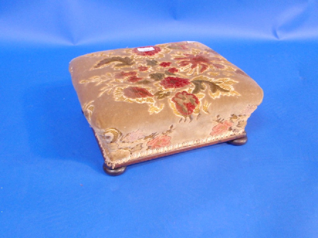 Appraisal: A Victorian mahogany footstool with sculptured velvet floral covering and