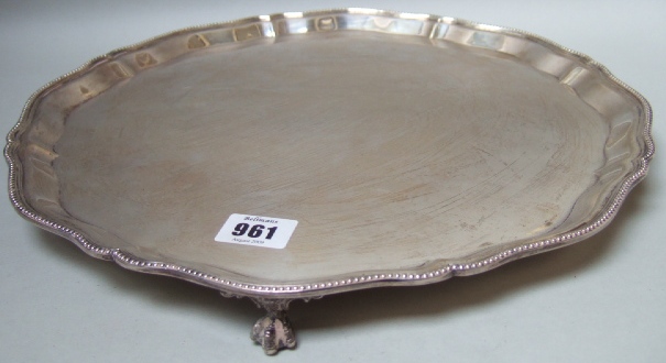 Appraisal: A silver shaped circular salver decorated with a beaded edge