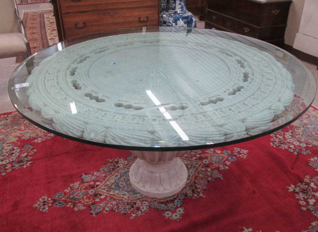 Appraisal: WHITE MARBLE PEDESTAL DINING TABLE featuring a relief-carved white marble