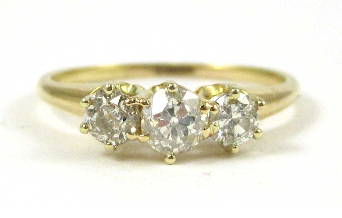 Appraisal: DIAMOND AND FOURTEEN KARAT GOLD THREE-STONE RING The yellow gold