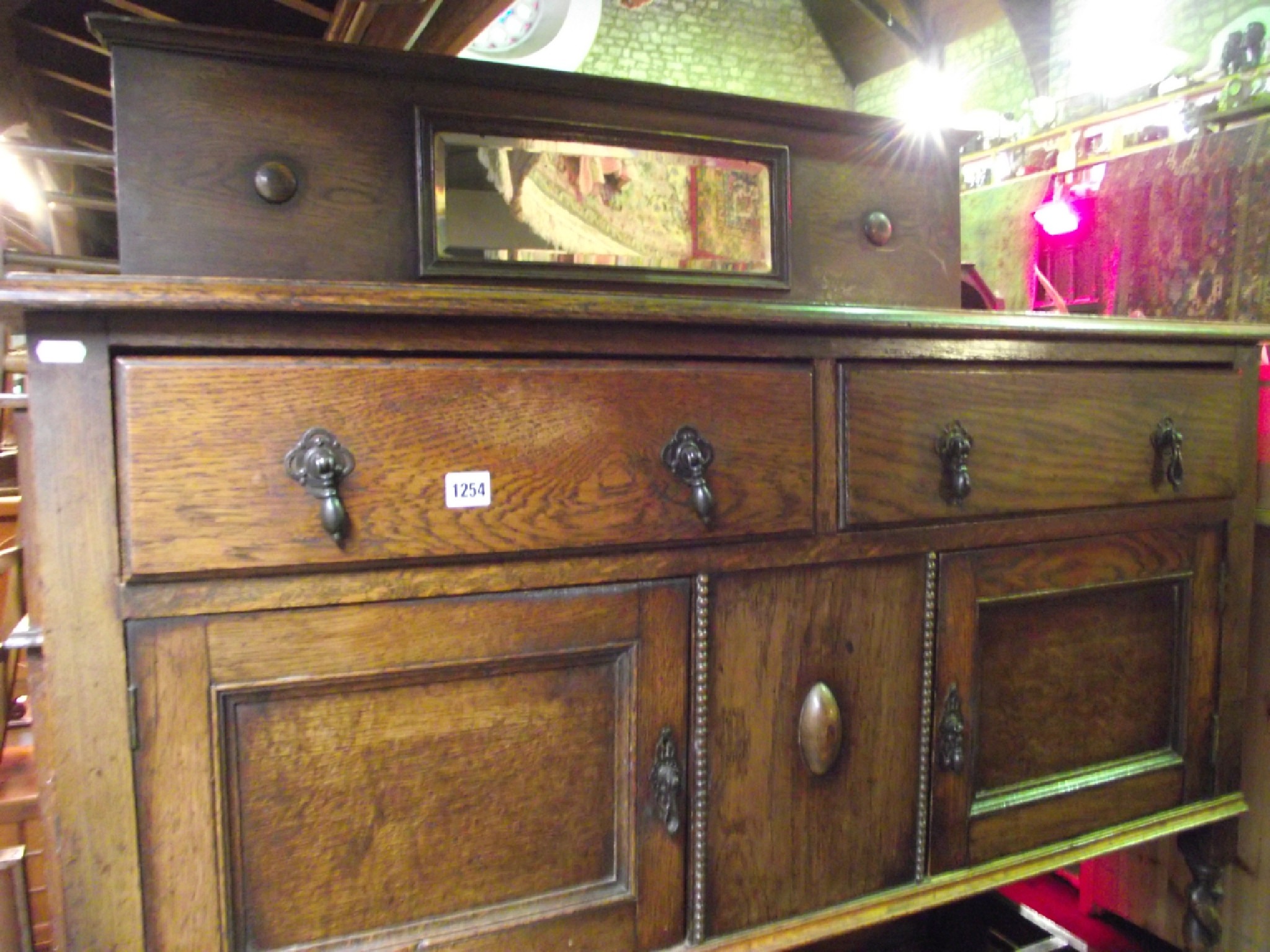 Appraisal: An Edwardian s oak sideboard the shallow raised back enclosing