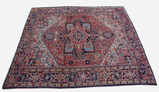 Appraisal: A HERIZ RUST GROUND CARPET decorated a central polygonal medallion