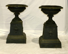 Appraisal: A pair of cast iron campagna form urns on stepped