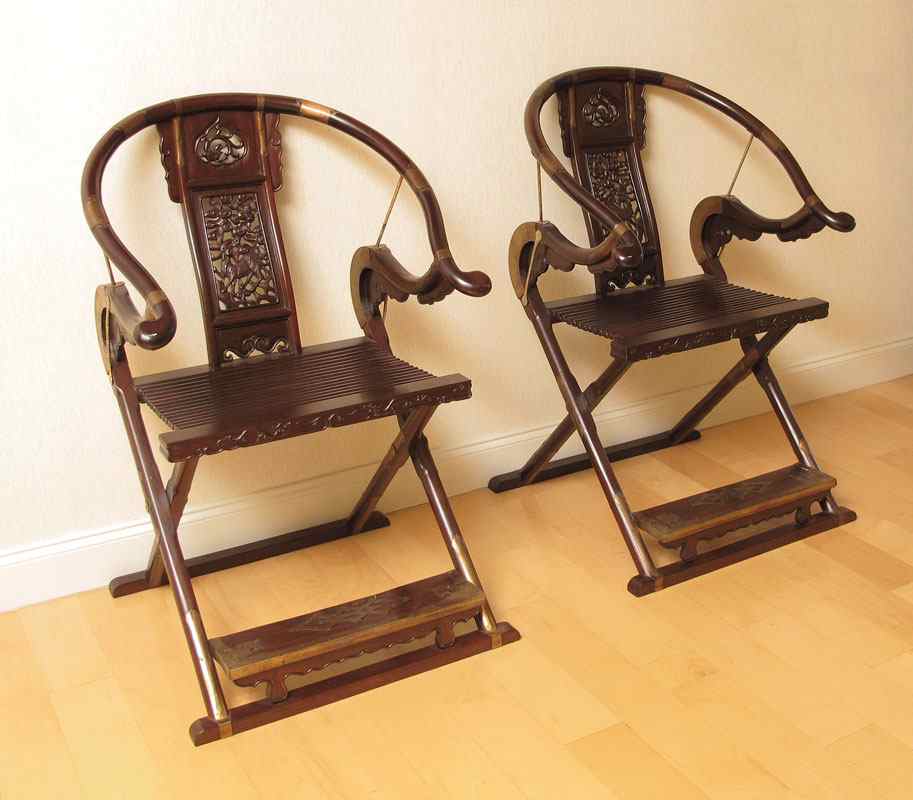 Appraisal: PAIR OF CARVED ORIENTAL FOLDING CHAIRS Approx '' h x