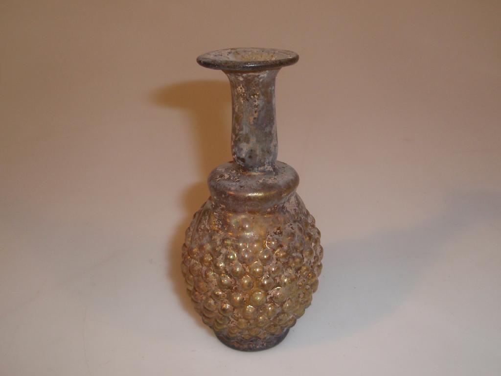 Appraisal: A Roman olive-green mould-blown glass grape flask the flaring mouth