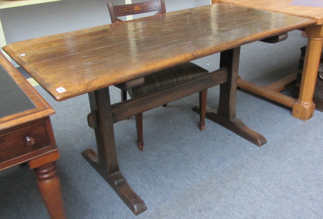 Appraisal: A th century style oak rectangular dining table raised on