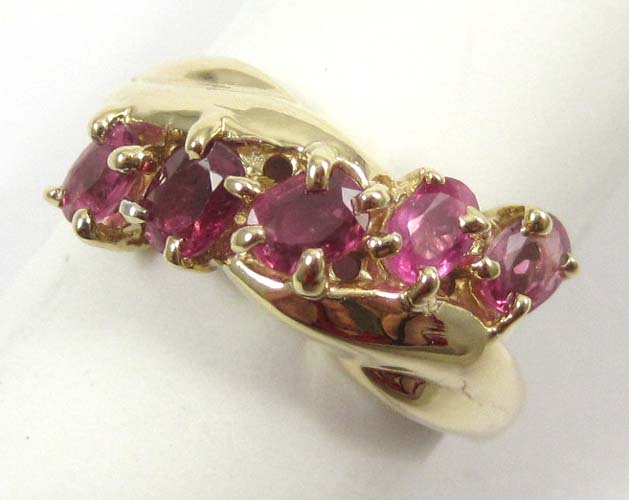 Appraisal: RUBY AND FOURTEEN KARAT GOLD RING set with five oval-cut