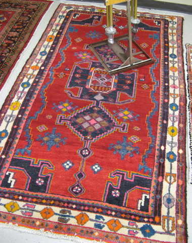 Appraisal: PERSIAN TRIBAL AREA RUG geometric design on red ground hand