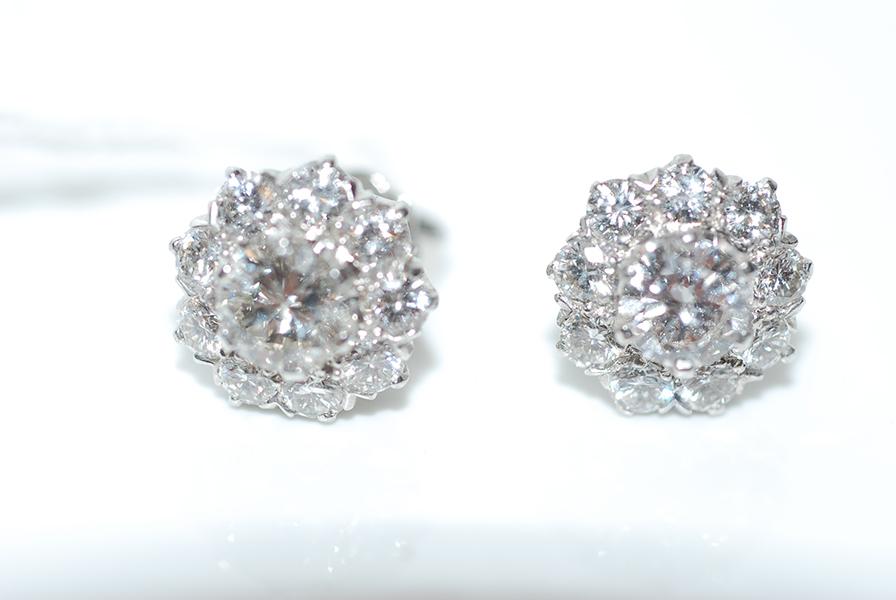 Appraisal: A PAIR OF DIAMOND CLUSTER EARRINGS IN CT WHITE GOLD