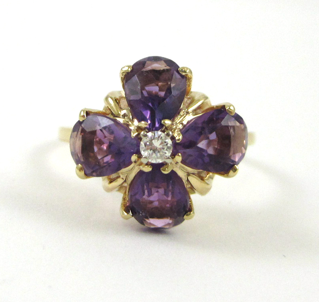 Appraisal: FOURTEEN KARAT GOLD AMETHYST AND DIAMOND RING having four pear-cut