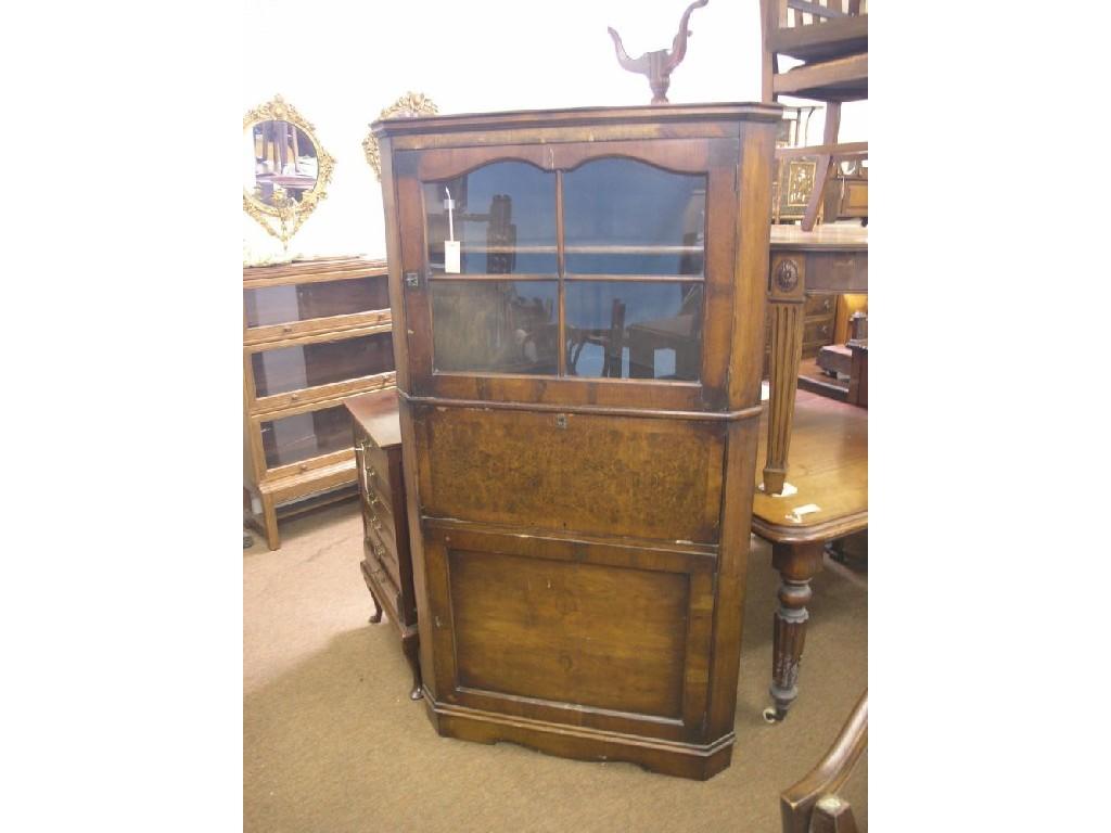 Appraisal: An early th century walnut corner-fitting secretaire cabinet glazed door