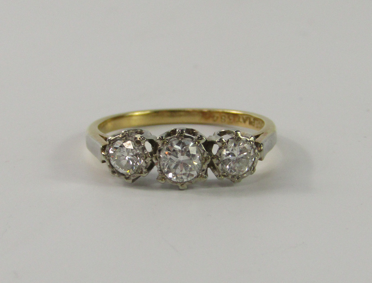 Appraisal: An ct gold platinum and diamond three stone ring claw