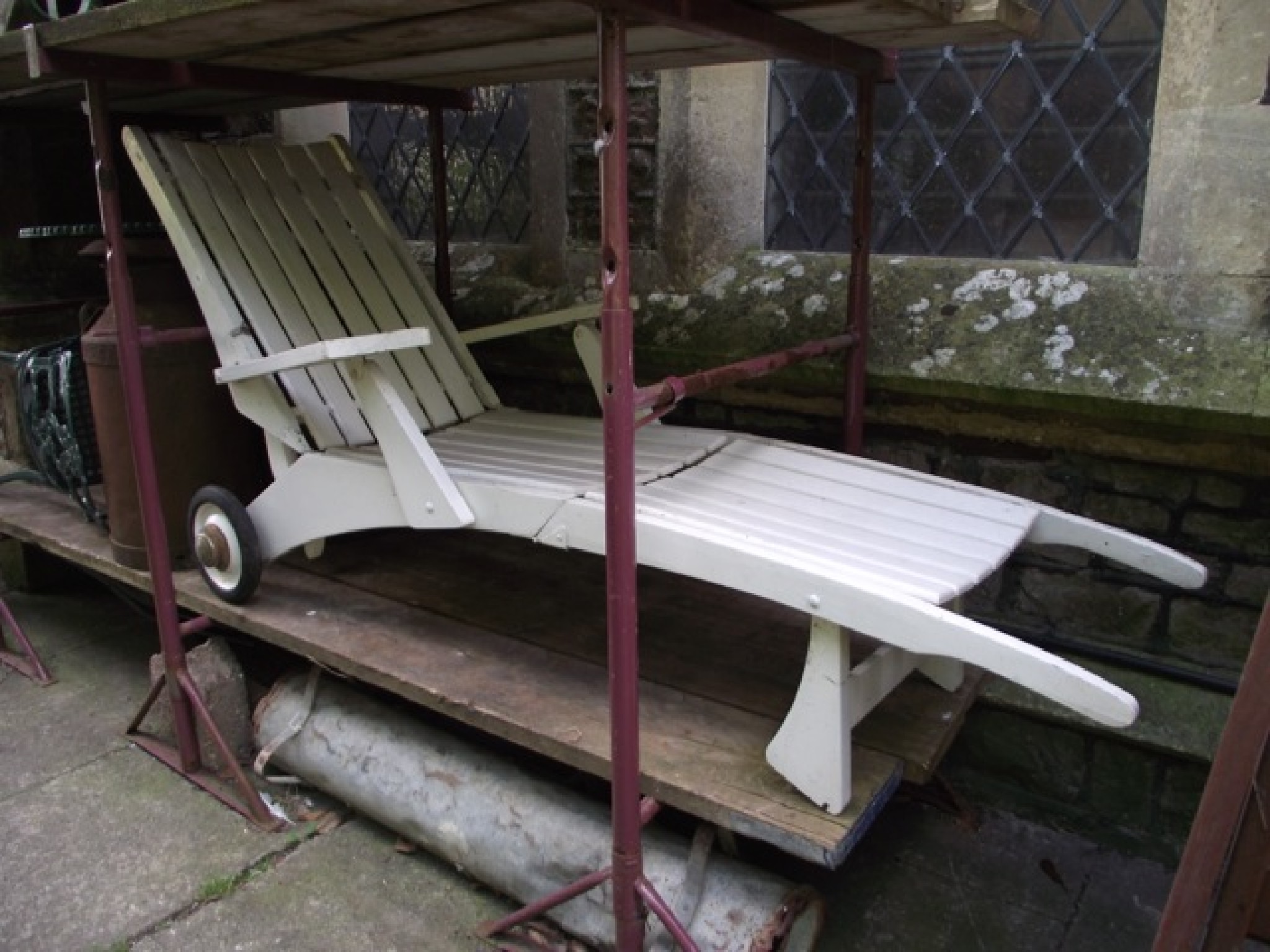 Appraisal: A cream painted wooden adjustable garden lounger with open arms