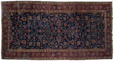 Appraisal: Persian rug repeating floral designs on dark blue field ft