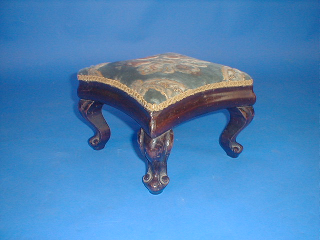 Appraisal: A Victorian rosewood foot stool of concave form with scroll