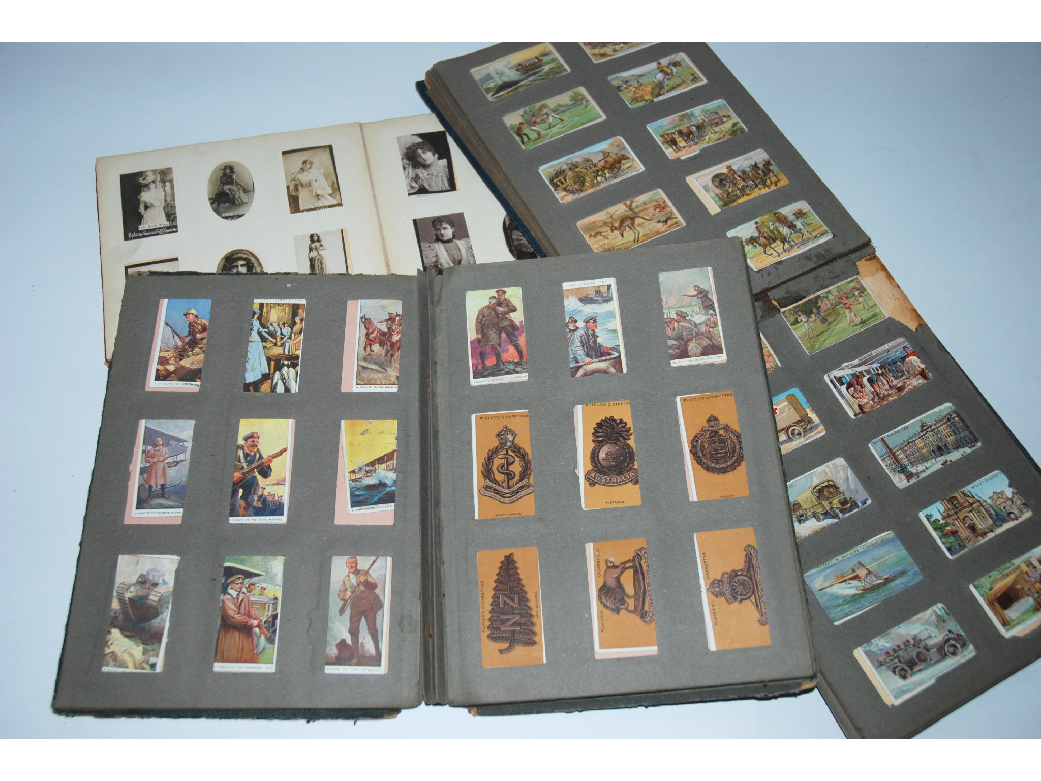 Appraisal: Four various albums of cigarette cards and loose examples