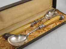 Appraisal: A cased pair of Victorian silver salad servers with ivory