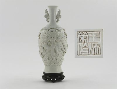 Appraisal: A Chinese white-glazed vase applied with a fierce scaly horned