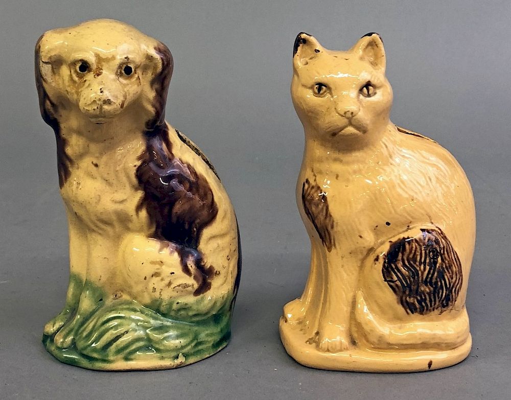 Appraisal: Redware Cat Dog Penny Banks Two redware cream glazed cat