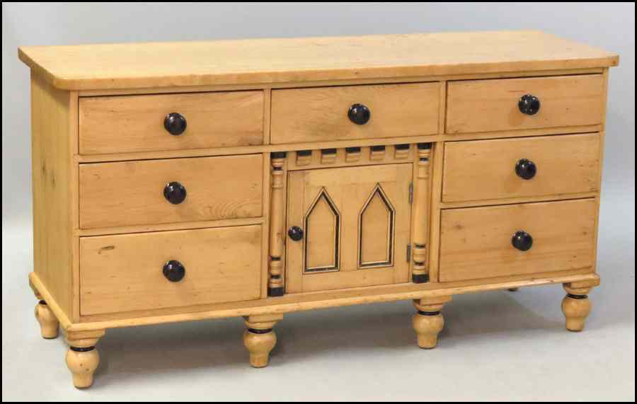 Appraisal: CARVED AND PAINTED PINE SEVEN DRAWER DRESSER With lower storage