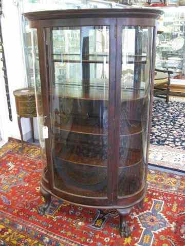 Appraisal: Mahogany China Cabinet bowfront mirrored back wooden shelves '' wide