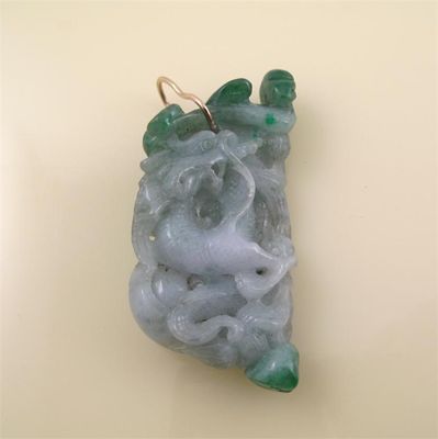 Appraisal: A jade pendant the jadeite plaque carved to depict a