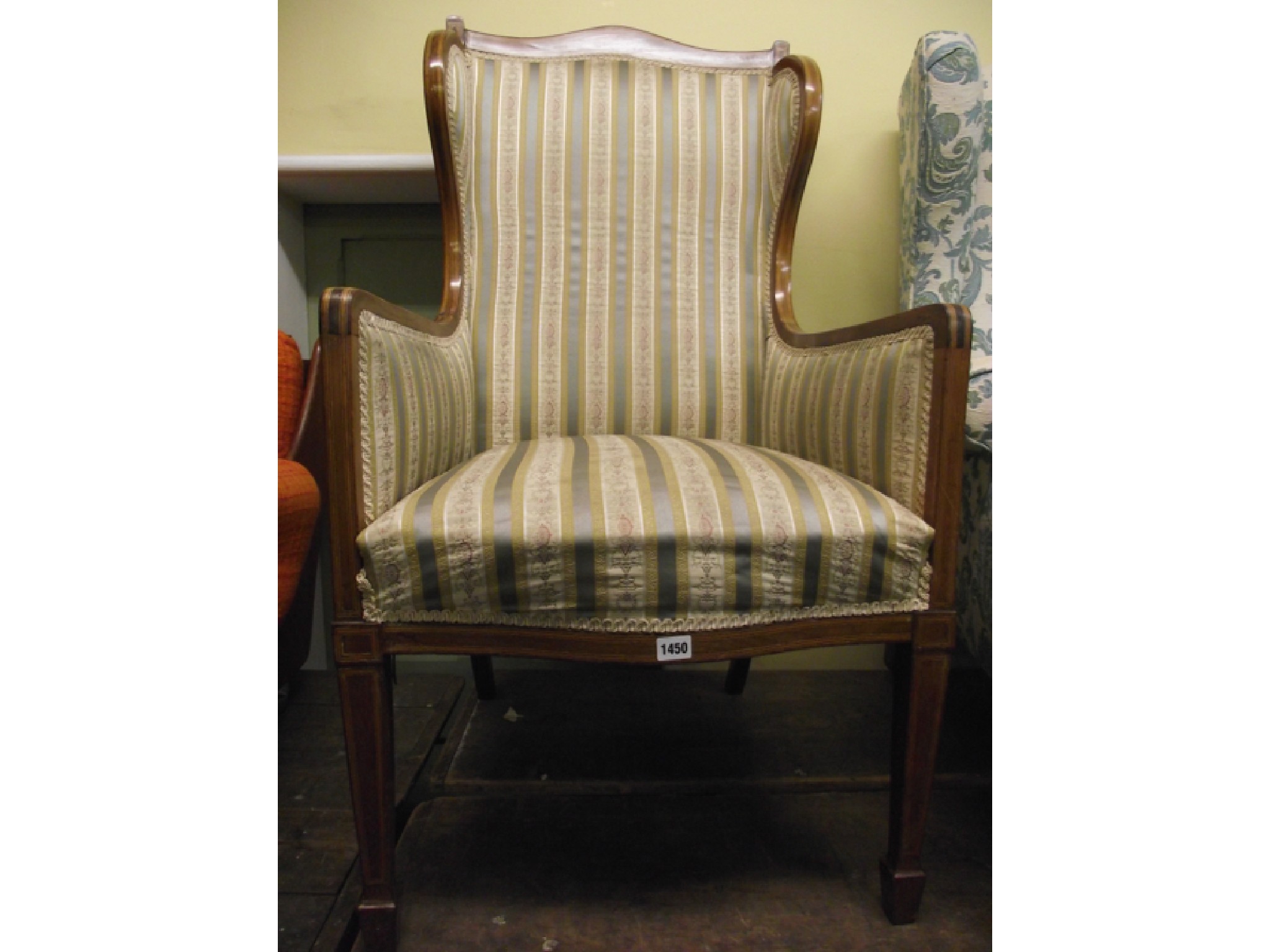 Appraisal: An Edwardian mahogany wing chair in the Georgian manner the